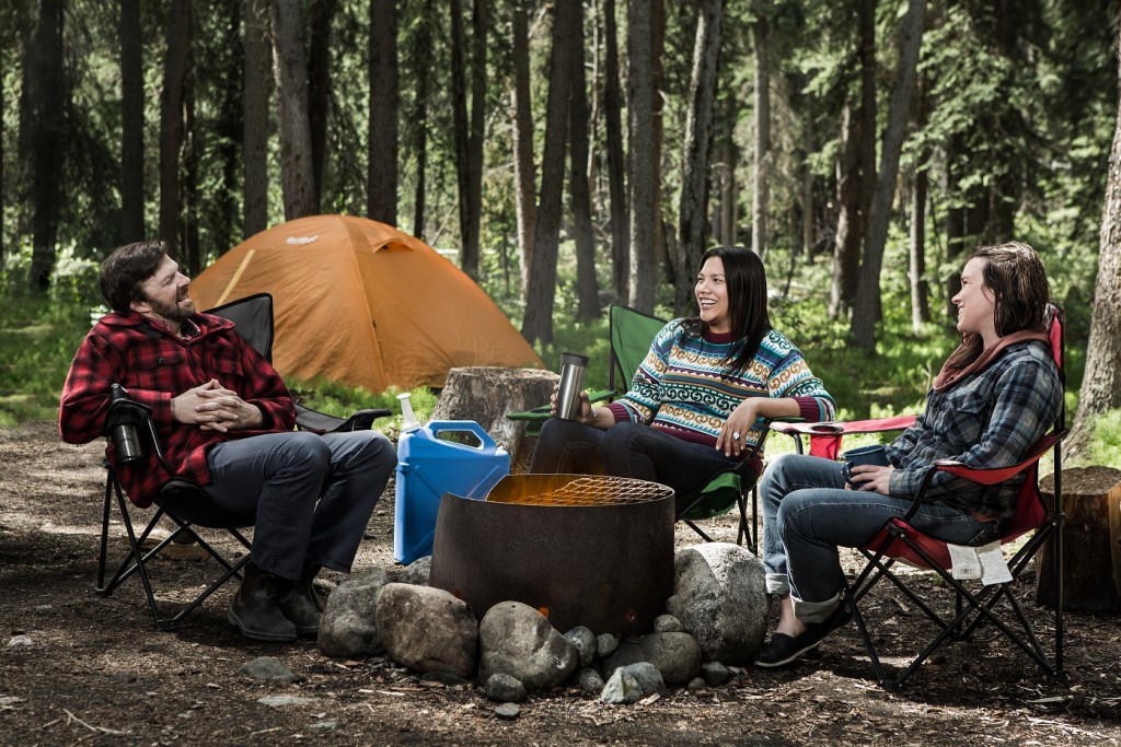 People sit around a campfire.