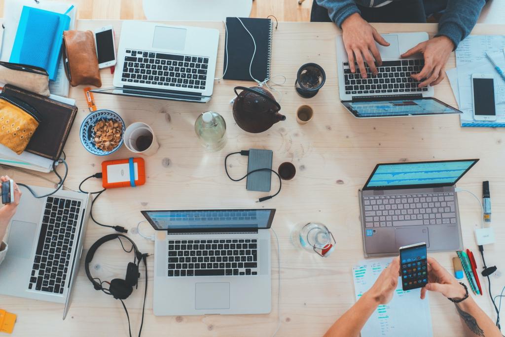 Laptops open on a boardroom table