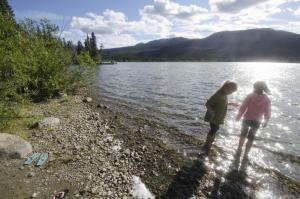 Kids at cobble beach at Simpson Lake Campground, Yukon