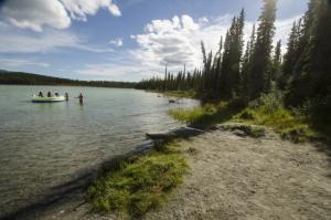 Swimmers at the beach, Kookatsoon Recreation Site, Yukon.