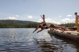 Diving off the dock at Tatchun Lake Campground, Yukon.